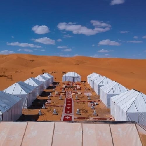 Luxury desert camp near Merzouga in Sahara Desert with elegant tents and peaceful dunes featured by moroccocameltrips experience.