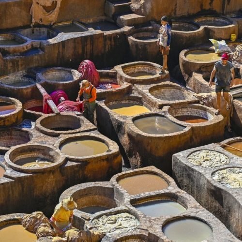Traditional leather tanneries in Fez medina with colorful dye pits featured during 4 days tour from Tangier to Marrakech.